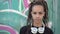 Portrait of young modern woman against graffiti background. Modern urban youth. Attractive hipster woman with dreadlocks