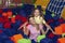 Portrait of young mother and her teen daughter playing together at foam ball pool in family recreation centre