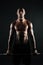 Portrait of young muscular afro american man holding barbell