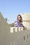 Portrait of a young muslim woman behind monument building at beach