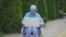 Portrait young muslim woman disabled in a traditional scarf uses a laptop sitting in a wheelchair