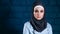Portrait of young Muslim woman wearing black hijab
