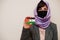 Portrait of young muslim woman wearing formal wear, protect face mask and hijab head scarf, hold Sahrawi flag card against