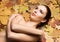 Portrait of young, natural and healthy woman over autumn background. Healthcare, spa, makeup and face lifting concept.