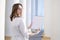 Portrait of a young nurse, medical university student standing with a phonendoscope and a blank sheet of paper, happy female