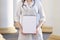 Portrait of a young nurse, medical university student standing with a phonendoscope and a blank sheet of paper, happy female