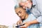 Portrait of young and old people grandfather and grandson together using a modern smart phone - family and friends concept with