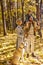 Portrait of young optimistic family in park in the evening, sunny weather