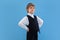 Portrait of a young orthodox jewish boy isolated on blue studio background, meeting the Passover