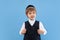 Portrait of a young orthodox jewish boy isolated on blue studio background, meeting the Passover