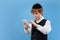 Portrait of a young orthodox jewish boy isolated on blue studio background, meeting the Passover