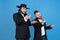 Portrait of a young orthodox jewish men isolated on blue studio background, meeting the Passover