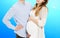 Portrait of young pair pending the kid  on blue background, Young attractive couple: pregnant mother and happy father,
