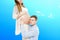 Portrait of young pair pending the kid isolated on blue background, Young attractive couple: pregnant mother and happy father,