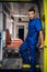 Portrait of a young paramedic in a uniform standing in the back of an ambulance car