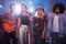 Portrait of young performers standing on stage at nightclub