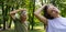 A portrait of a young physiotherapist training outdoors in the park with senior patient.