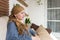 Portrait of young positive adult female cancer patient sitting in living room, smiling.