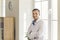 Portrait of young positive man office worker manager in white official shirt