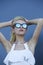 Portrait of young pretty blond model in cool mirror stylish sunglasses,