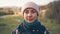 Portrait of young pretty calm girl looks at camera, blurred spring nature background