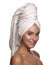 Portrait of a young pretty and charming smiling girl after the shower with a towel on her head