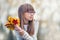 Portrait of a young pretty girl who was cheerfully playing with autumn maple leaves.Girl sitting on colorful autumn leaves.