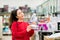 Portrait of young pretty woman chooses a mini fan in a home appliance store. The concept of consumerism