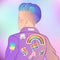 Portrait of a young pretty woman with short shaved pixie undercut. Rainbow LGBT symbols as pins or patches on her back