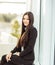 Portrait of a young prospective female employee on the background of a large window