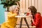 portrait of young retro styled women looking at golden fish in aquarium doll