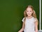 Portrait of young schoolgirl near chalkboard