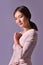 Portrait of young sexual model in a purple dress posing in the studio