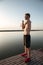 Portrait of a young shirtless sportsman warming up before jogging