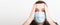 Portrait of young shocked sick man in medical mask with coronavirus word at white background. Respiratory protection. Coronavirus