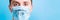 Portrait of young sick man in medical mask with stop word at blue background. Respiratory protection. Coronavirus