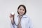 Portrait of a young and skilled doctor, medical student, intern holding up a stethoscope. Isolated on a white background