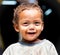 Portrait of a young smeared sherpa boy smiling in Kathmandu, Ne