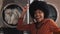 Portrait of young smiling African American woman funny dancing in the self-service public laundry.