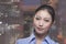 Portrait of young smiling businesswoman, cityscape of Beijing in background