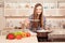 Portrait of young smiling cooker tasting her soup