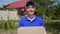 Portrait of a young smiling delivery man courier. Courier with a cardboard box.