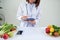 Portrait of young smiling female nutritionist in the consultation room. Dietitian working on diet plan