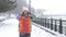 Portrait of young smiling motivated and focused sporty active girl in winter sportswear. The snowy nature in the park