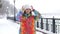 Portrait of young smiling motivated and focused sporty active girl in winter sportswear. The snowy nature in the park