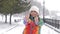 Portrait of young smiling motivated and focused sporty active girl in winter sportswear. The snowy nature in the park