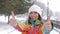 Portrait of young smiling motivated and focused sporty active girl in winter sportswear. The snowy nature in the park