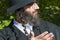 Portrait of young smiling orthodox Jewish man looking up