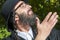 Portrait of young smiling orthodox Jewish man looking up