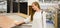 Portrait of young smiling woman choosing wood laminated flooring in shop